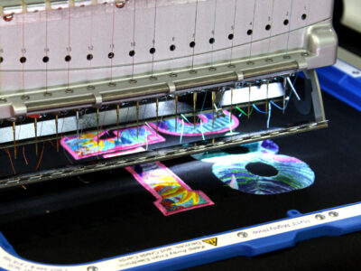 Melco Embroidery Machine with 11x13" Mighty Hoop embroidering the number 18