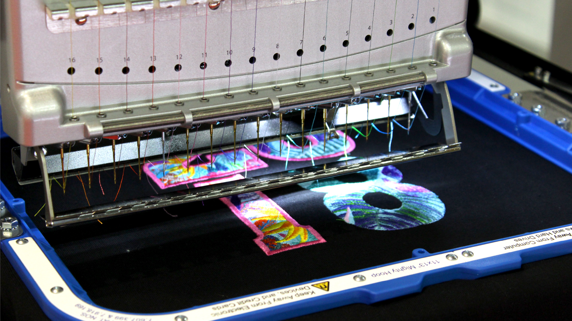 Melco Embroidery Machine with 11x13" Mighty Hoop embroidering the number 18