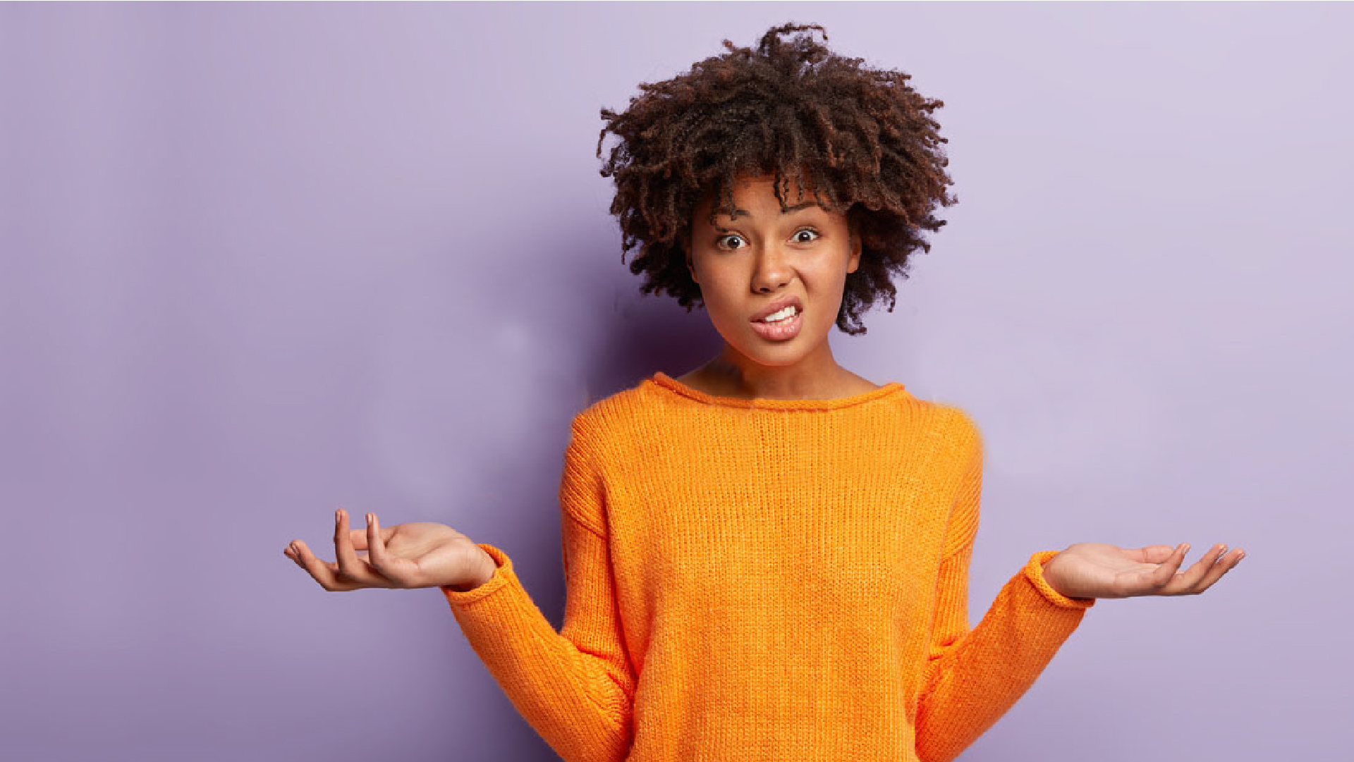 Black woman with orange jumper looking confused