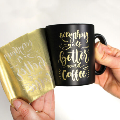 Black Mug with gold design being transferred using Forever Transfers Multi-Trans Gold Paper