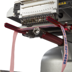 Melco EMT16X Embroidery Machine embroidering on a dog collar with white background