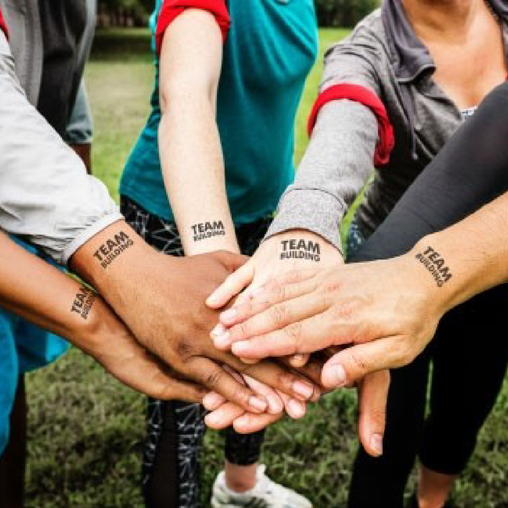 Group of peoples hands all together with team tatoos using Forever A4 Laser Tattoo Transfer Paper