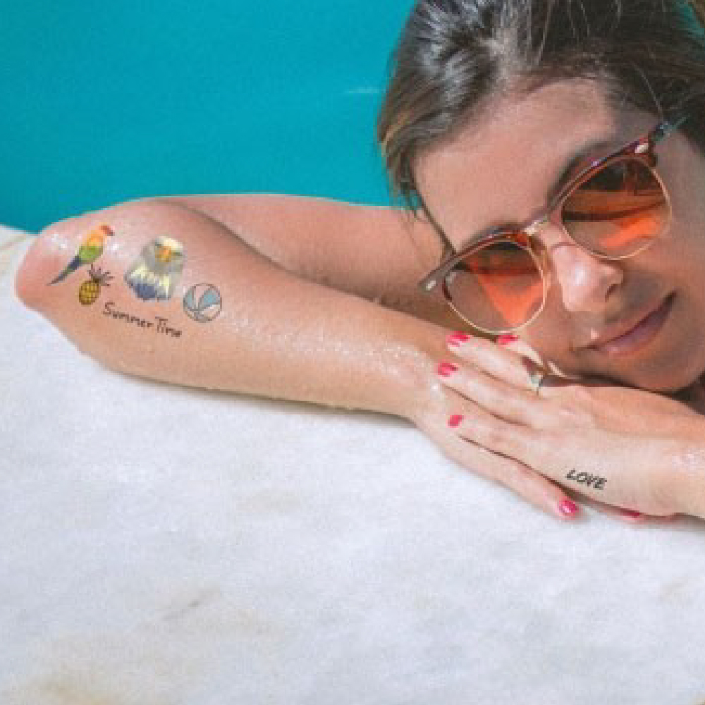 Woman by pool with tatoos using Forever A4 Laser Tattoo Transfer Paper