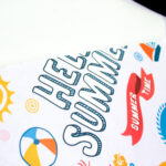 Hello Summer print being transferred onto a white shirt using Forever Laser Light No Cut Paper