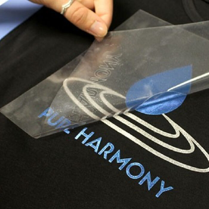 Pure harmony logo being transferred onto black shirt using Sef Metalflex Vinyl