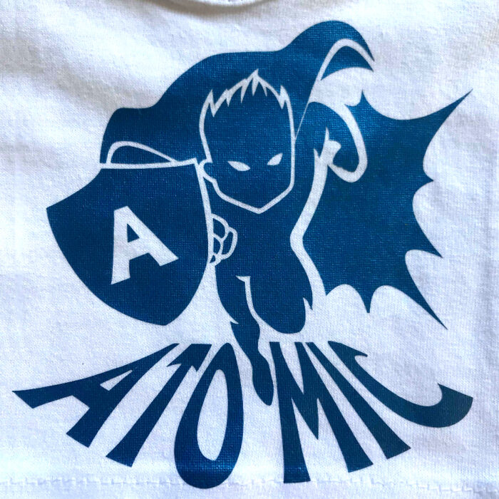 White fabric with super hero design made with Sef Flex Cut Atomic Blue Vinyl