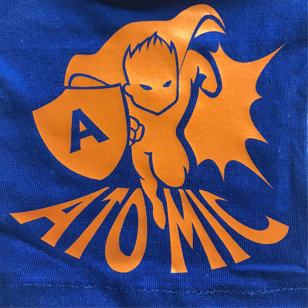 Blue fabric with super hero design made with Sef Flex Cut Atomic Orange Vinyl