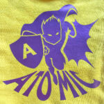 Yellow fabric with super hero design made with Sef Flex Cut Atomic Purple Vinyl