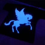 T-Shirt under UV Lamp showing glow in the dark designs made with Sef Flex Cut Sticky Night Club Vinyl