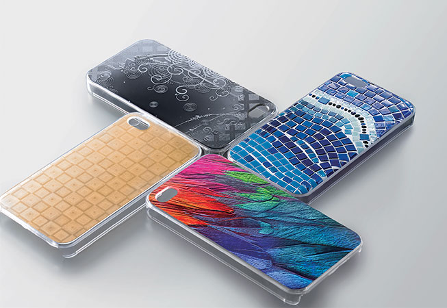 Four phone cases with different textural prints on grey background printed with Roland Versa UV Lef-2 Series Printers