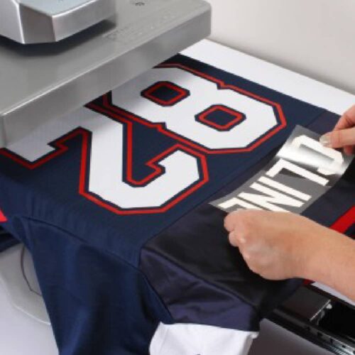 Placing transfer onto sports shirt with Stahls Hotronix Fusion IQ Heatpress