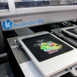 Kornit Avalanche HD6 printer with black garment design featuring gecko