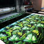 Large palm design being printed onto fabric using Kornit Presto