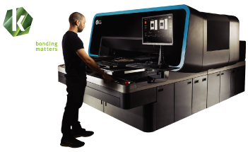 Man at Kornit Atlas Direct to Garment Printer with Kornit Digital Logo