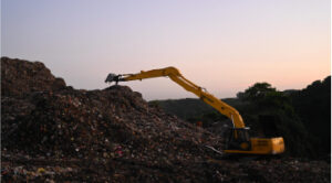 Digger on landfill site