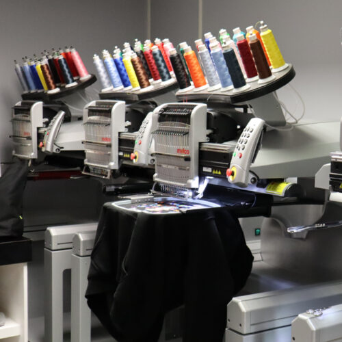 Melco Embroidery Machine with garments in Amaya Sales UK Showroom