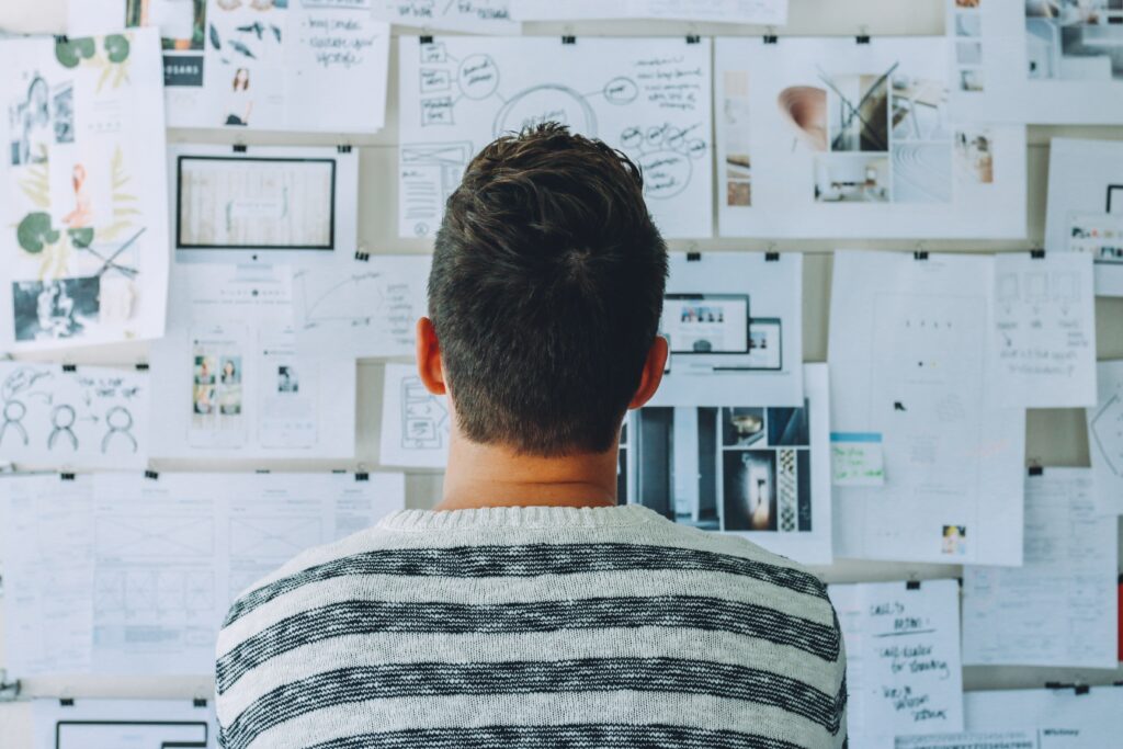 Person from behind looking at work board