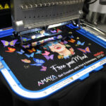 Melco EMT16X Embroidery Machine with 11×13″ Mighty Hoop embroidering on a garment