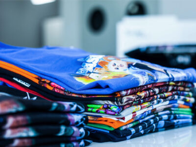 stack of t-shirts printed with texjet direct to garment printers