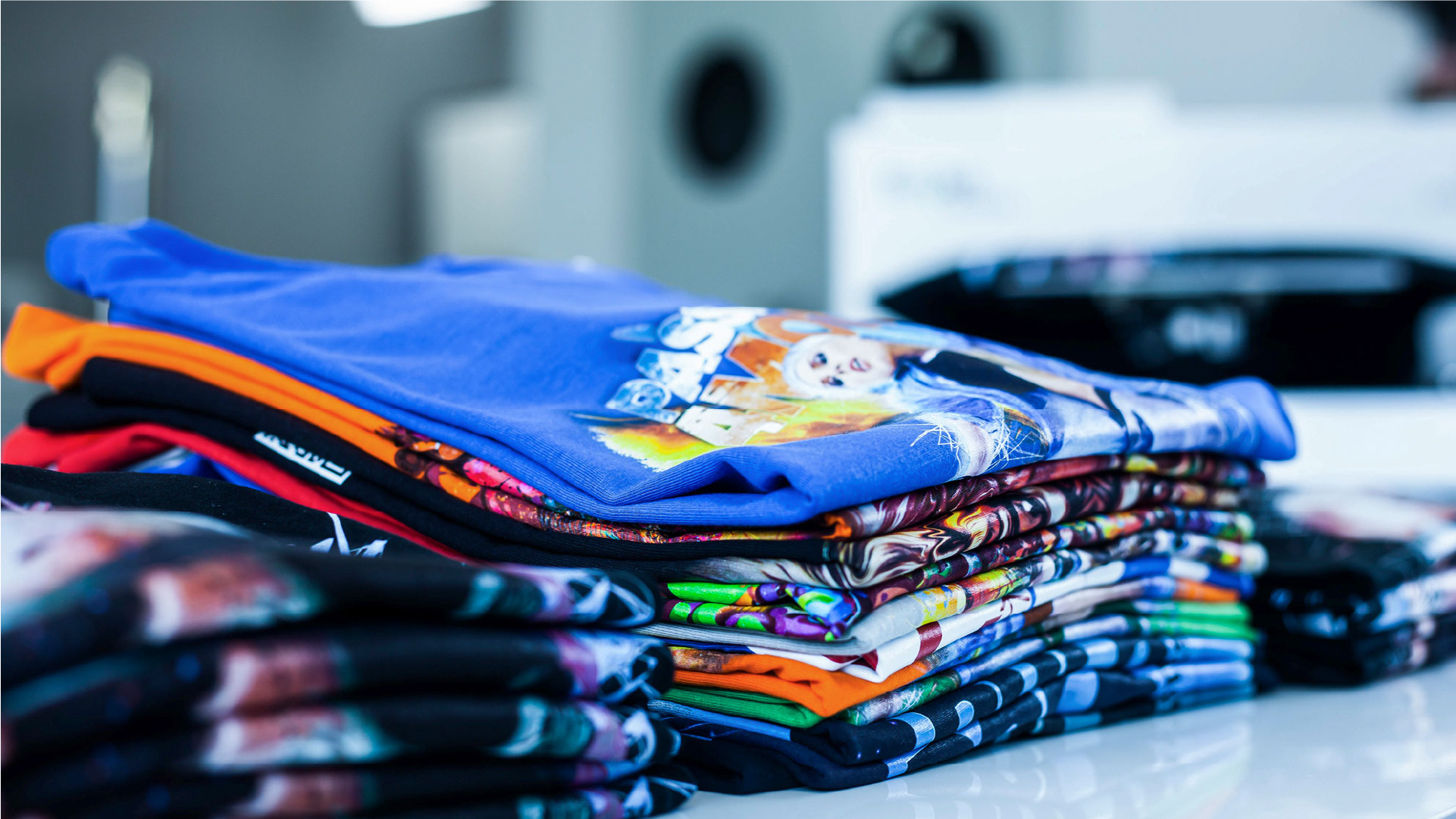 stack of t-shirts printed with texjet direct to garment printers